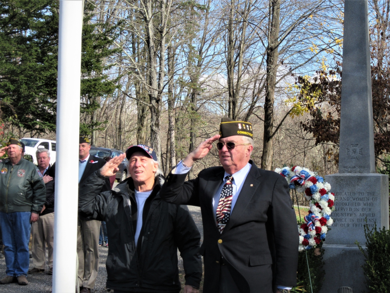 Jack Tyransky and Sandy Sanderson salute the American Flag after raising it.